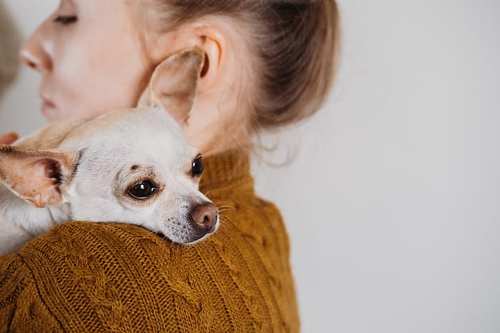 woman holding little dog