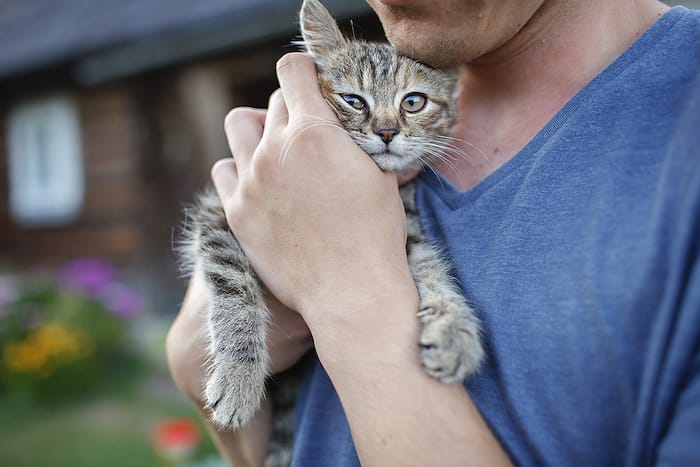 man holding cat